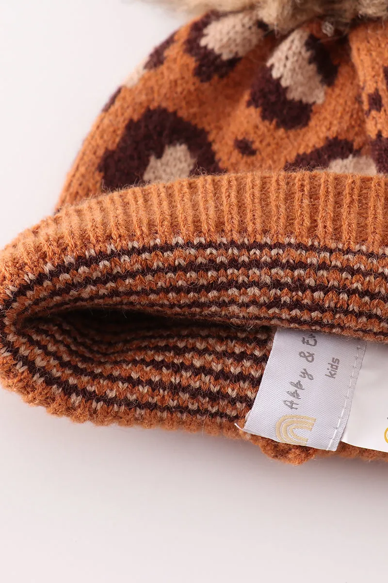 Brown pompom leopard cable beanie